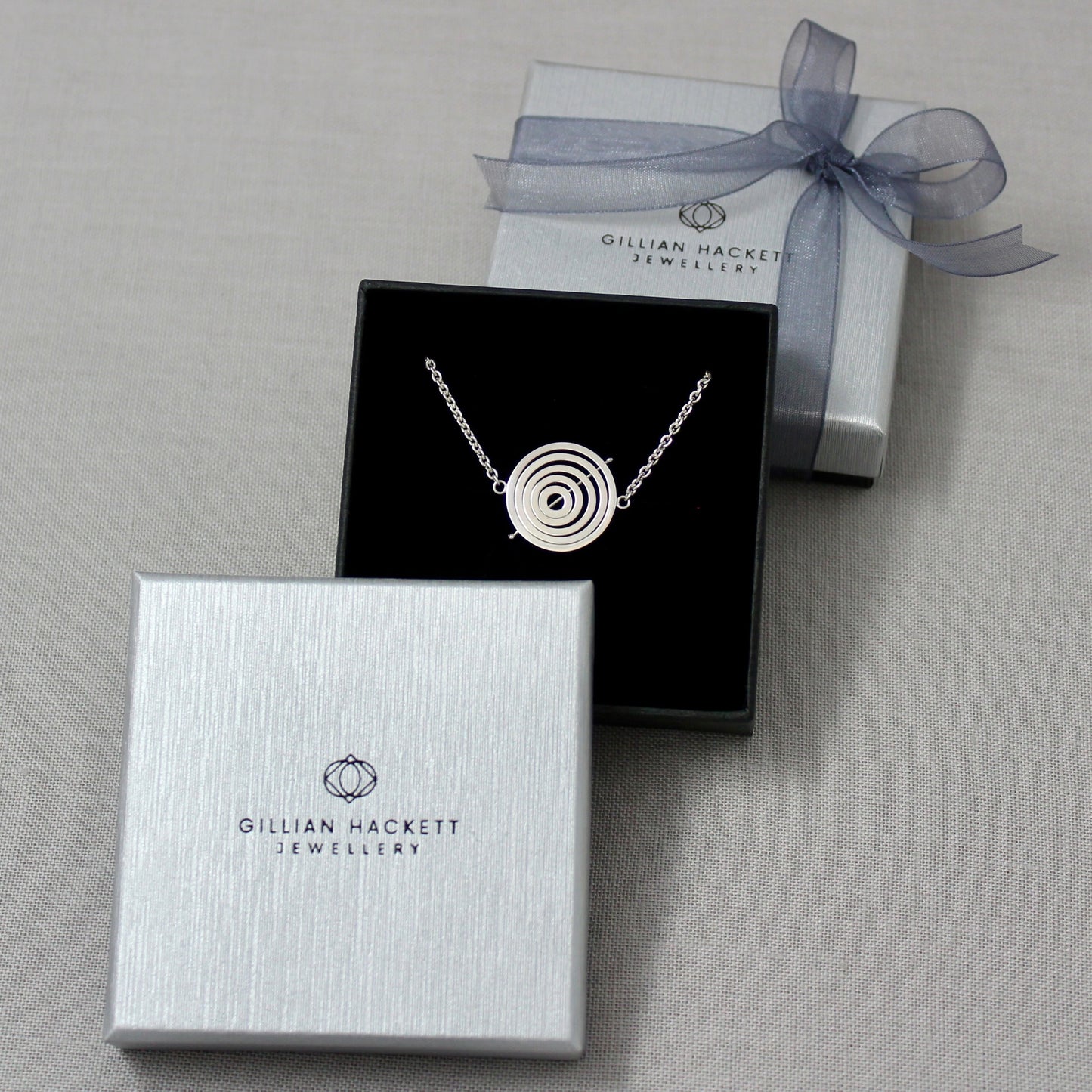 Handcrafted sterling silver kinetic choker in Gillian Hackett Jewellery luxury black gift box with logo on grey textured lid