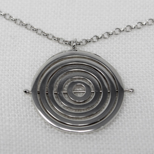 Sterling silver kinetic necklace with 5 concentric recycled square wire rings held by central pin, hanging on belcher chain
