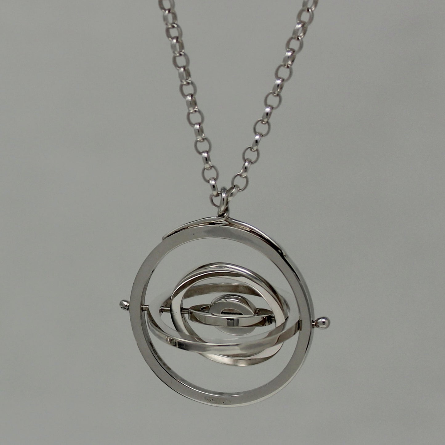 Hallmarked sterling silver kinetic pendant with 5 concentric circle rings pivoting on central pin, with chunky belcher chain